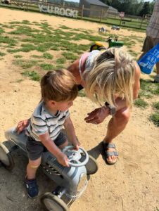 Polli with Logan on little car