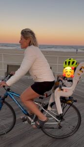 Polli riding on the boardwalk with Logan
