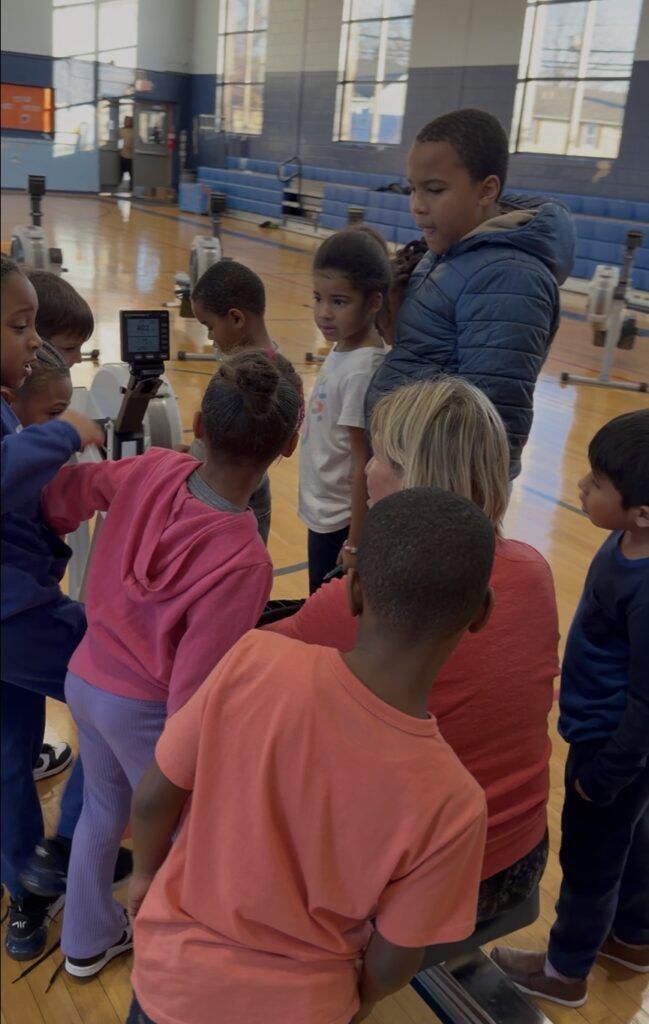 Polli surrounded by kids rowing